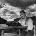 7th October 1939:  EXCLUSIVE American writer Ernest Hemingway (1899 - 1961) works at his typewriter while sitting outdoors, Idaho. Hemingway disapproved of this photograph saying, 'I don't work like this.'  (Photo by Lloyd Arnold/Hulton Archive/Getty Images)